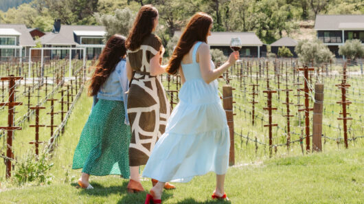 Three women walking in Elusa vineyard